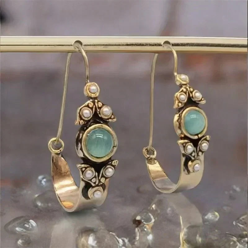 Retro pearl earrings with a green stone and a vintage design