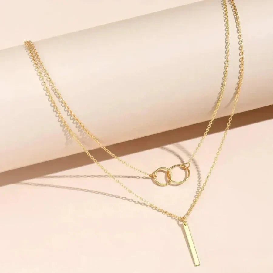 Multi-Strand Necklace with Rings and Elegant Bar Pendant