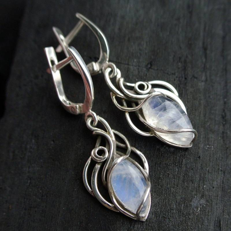 White glass earrings with a curved wire design