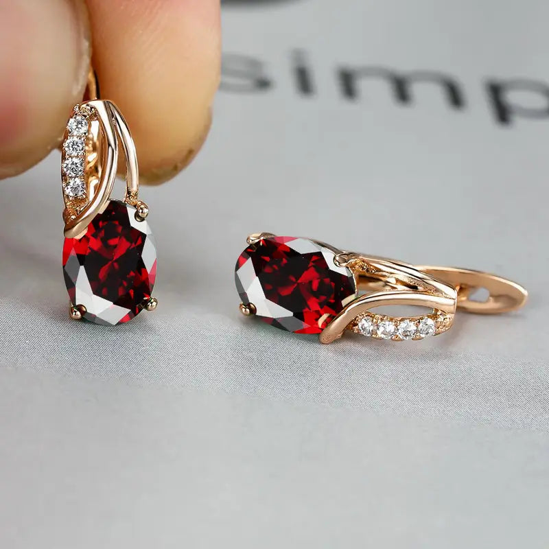 Earrings featuring sparkling ruby-red cubic zirconia stones, perfect for elegant occasions