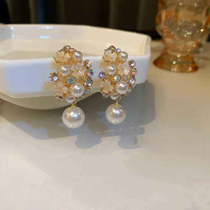 Elegant pearl earrings with floral motifs and sparkling gemstones