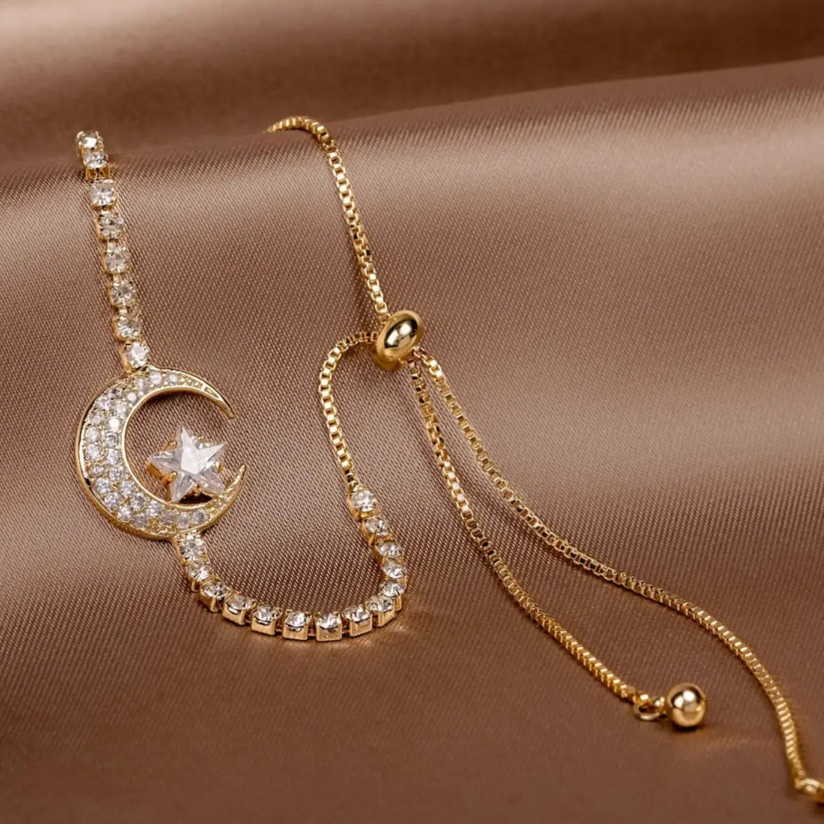 Bracelet with sparkling cubic zirconia stones and a moon and star pendant
