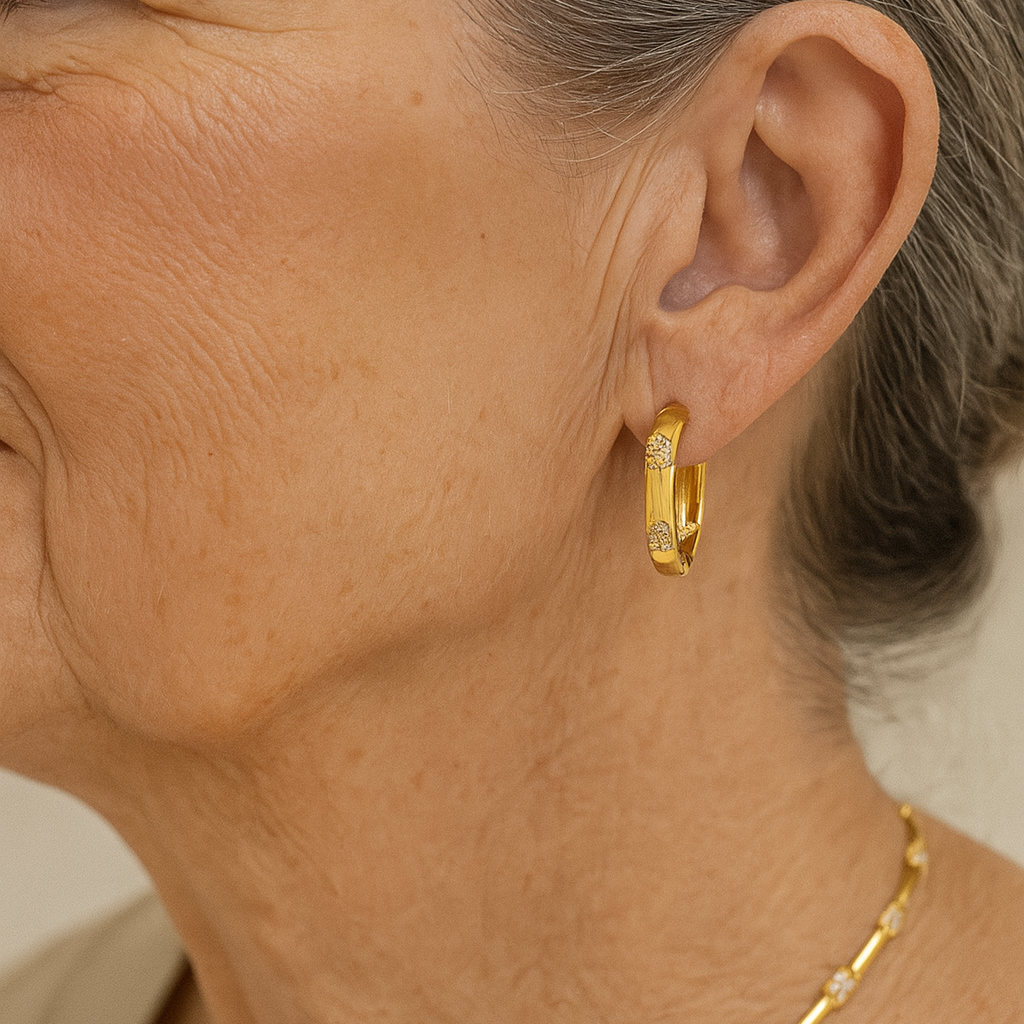 Gold-plated hoop earrings with floral motifs featuring sparkling cubic zirconia stones