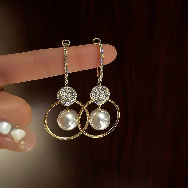 Elegant cubic zirconia earrings with sparkling pearls and glittering circles