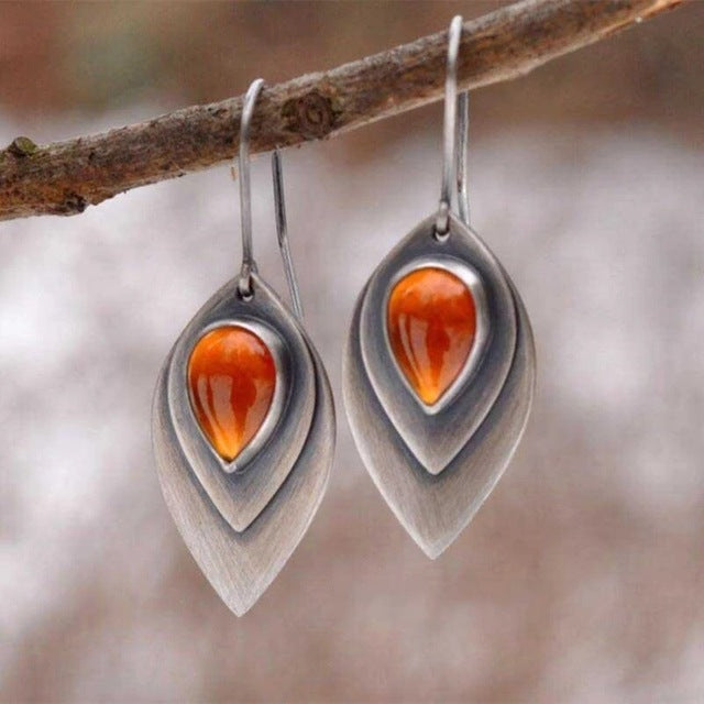 Vintage teardrop earrings with a bright orange stone