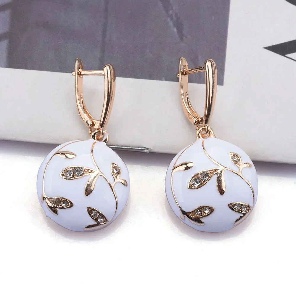 Elegant white enamel earrings featuring a rhinestone leaf design