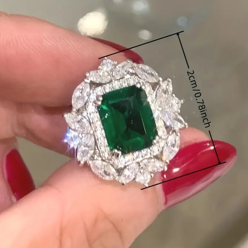 Luxurious earrings featuring emerald-green cubic zirconia and sparkling marquise-cut stones