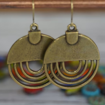 Antique bronze earrings featuring a sunray design
