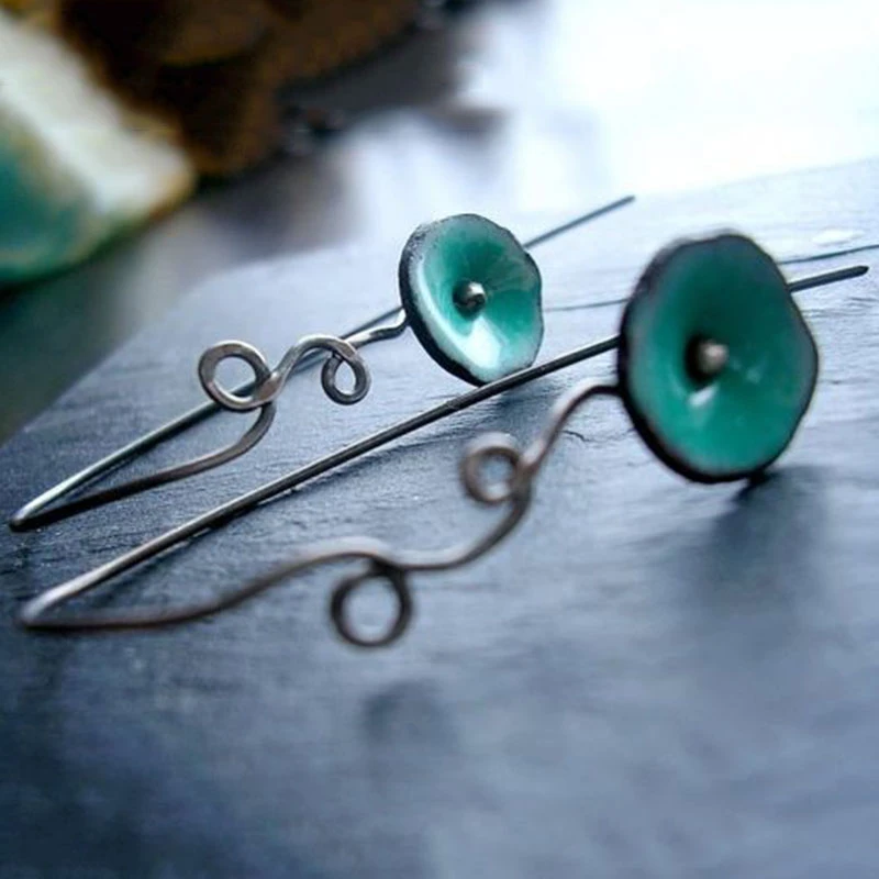 Flower earrings with green enamel and elegant wire detailing