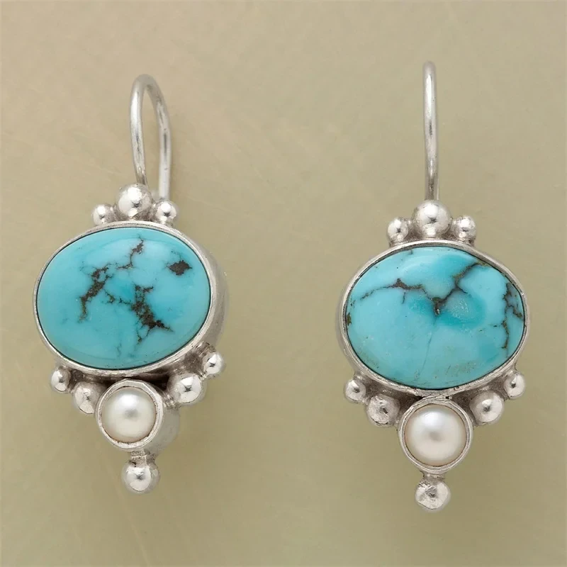 Vintage-style earrings featuring turquoise and pearls with delicate embellishments
