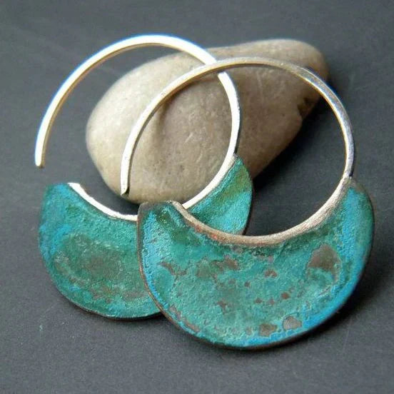 Handmade crescent-shaped earrings with a turquoise-effect patina
