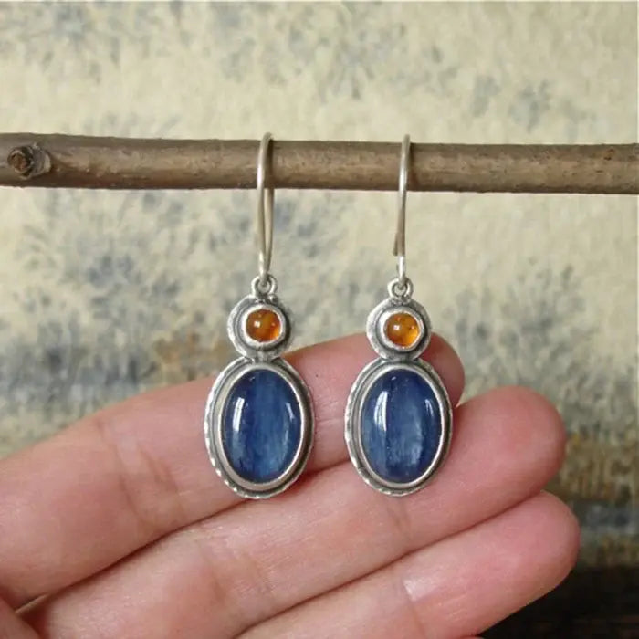 Oval blue kyanite earrings with shiny amber details