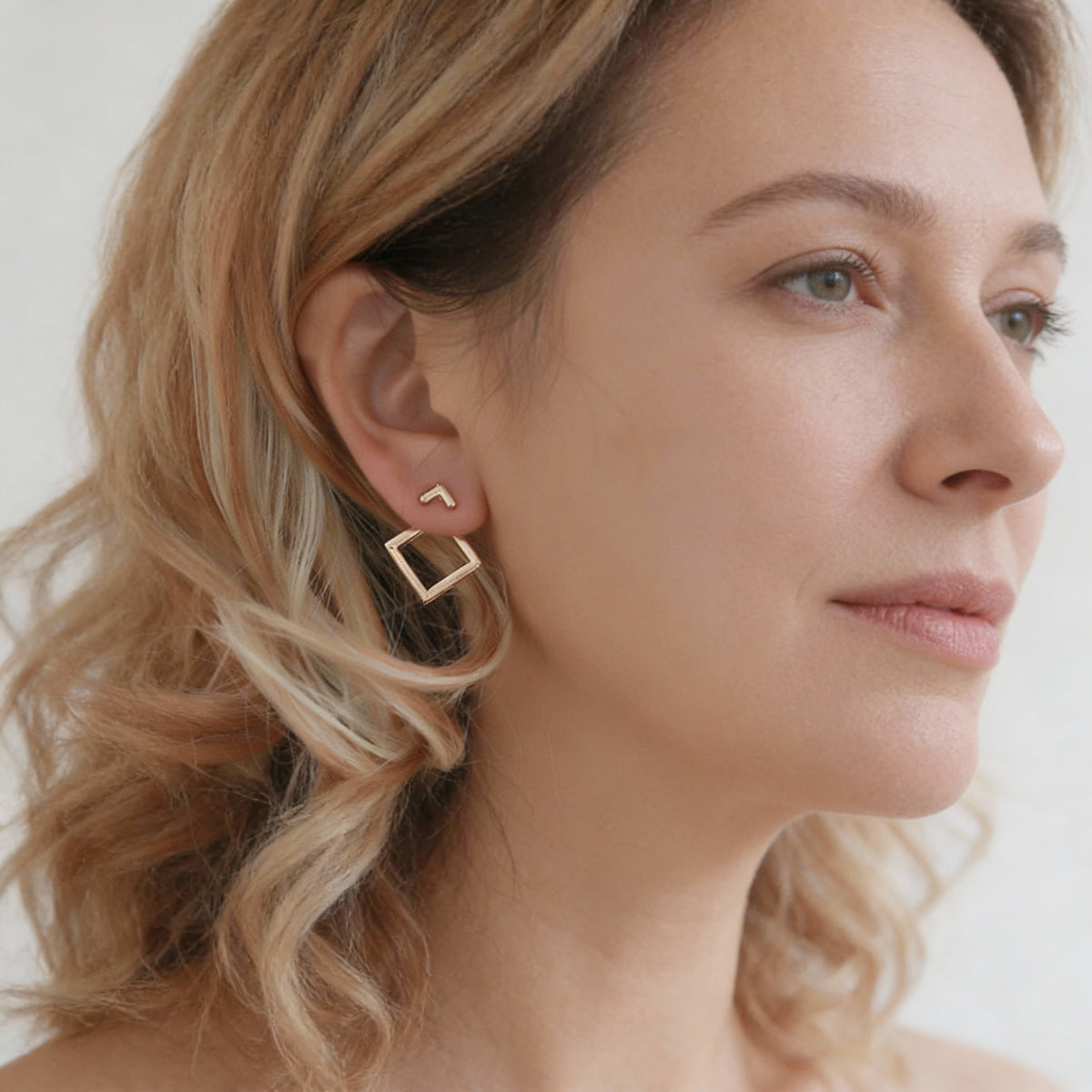 Trendy geometric earrings featuring a square and arrow design