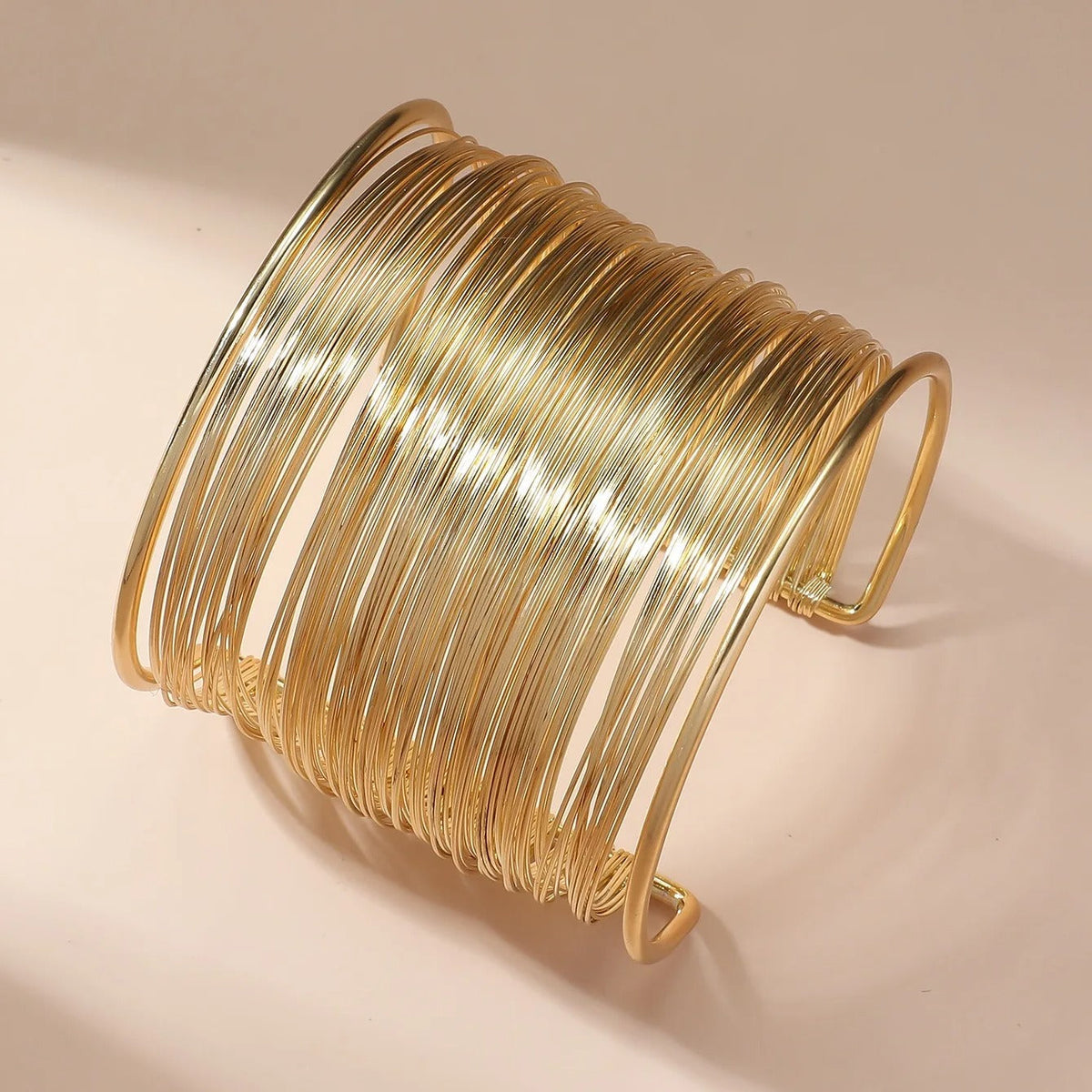 Spiral wrap bracelet with wire wrapping and a multi-layered design