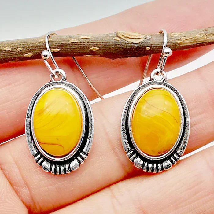 Vintage-style oval earrings with a sunny yellow cabochon stone