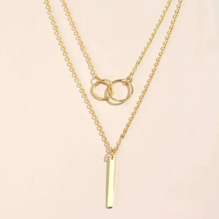 Multi-Strand Necklace with Rings and Elegant Bar Pendant