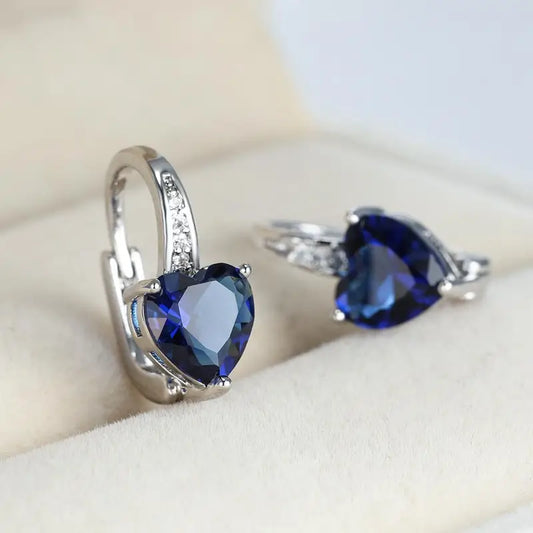 Heart-shaped earrings with sapphire-blue cubic zirconia and sparkling details