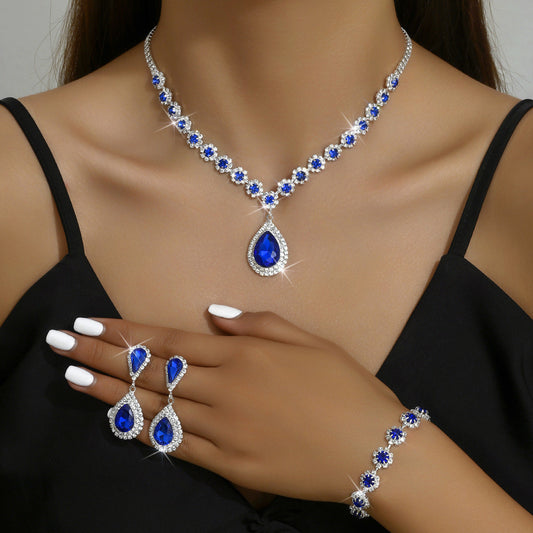 An elegant bridal jewellery set featuring imitation diamonds and a teardrop-shaped pendant, perfect for weddings and parties