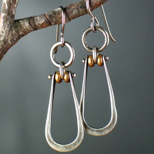 Rustic teardrop-shaped earrings with subtle pearl detailing