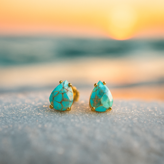 Teardrop-shaped turquoise earrings in a marine blue shade with gold detailing
