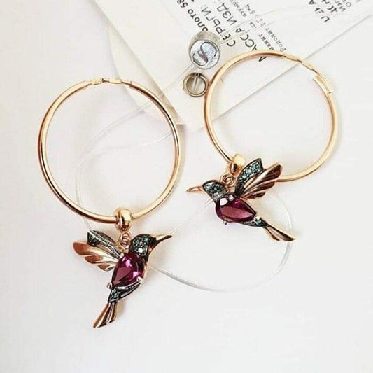 Rose gold hummingbird hoop earrings with sparkling gemstones