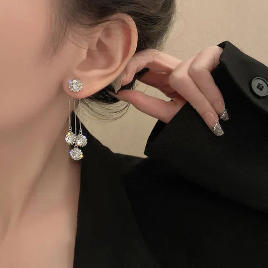 Cluster earrings featuring sparkling cubic zirconia stones with three dangling beads