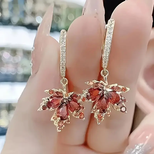 Elegant maple leaf earrings with sparkling red cubic zirconia stones