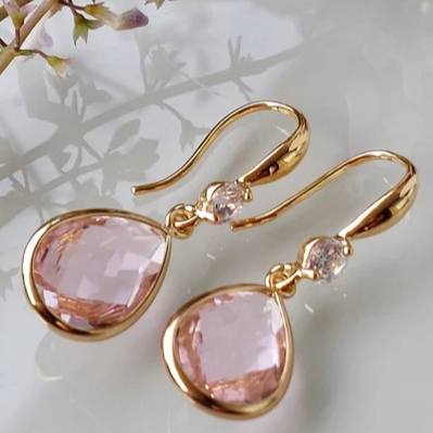 Elegant earrings featuring a pink teardrop-shaped stone and sparkling cubic zirconia