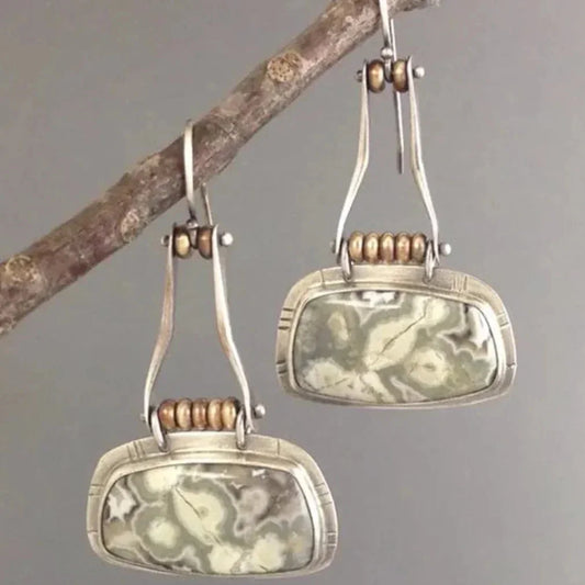 Vintage earrings featuring an aged stone pattern and an antique look