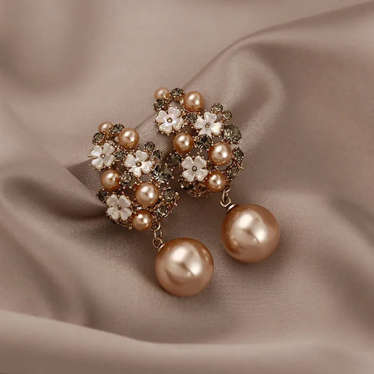 Elegant pearl earrings with floral motifs and sparkling gemstones
