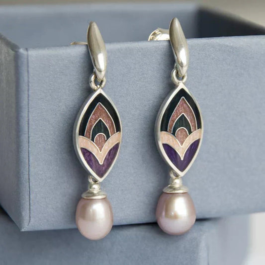 Elegant enamel earrings with a playful pattern and pink beads