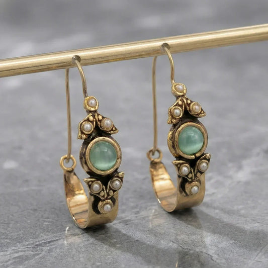 Retro pearl earrings with a green stone and a vintage design