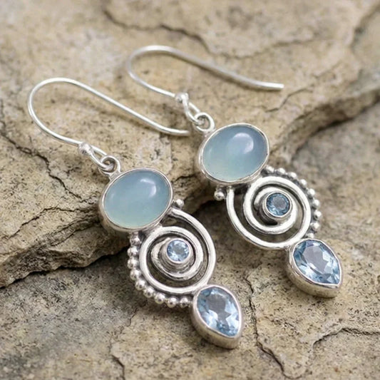 Sky-blue chalcedony and topaz earrings in a spiral design