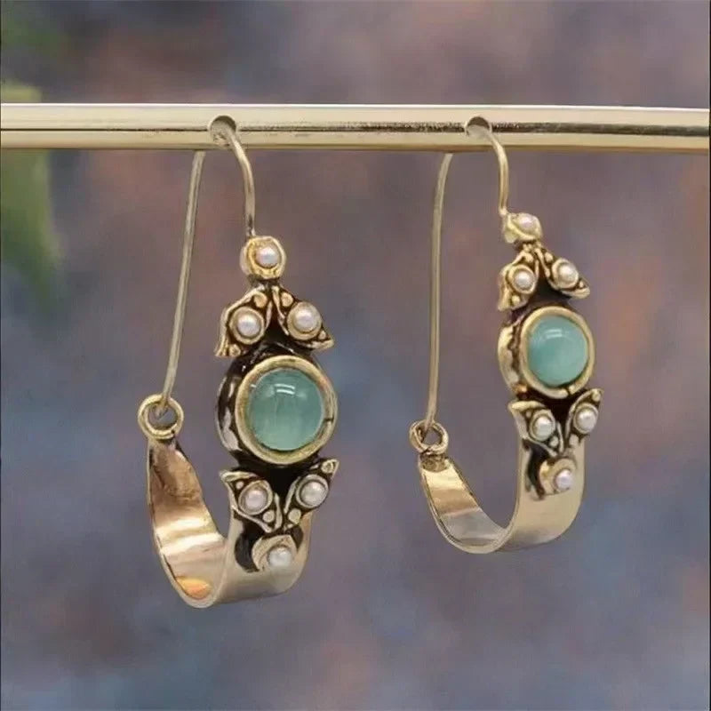 Retro pearl earrings with a green stone and a vintage design