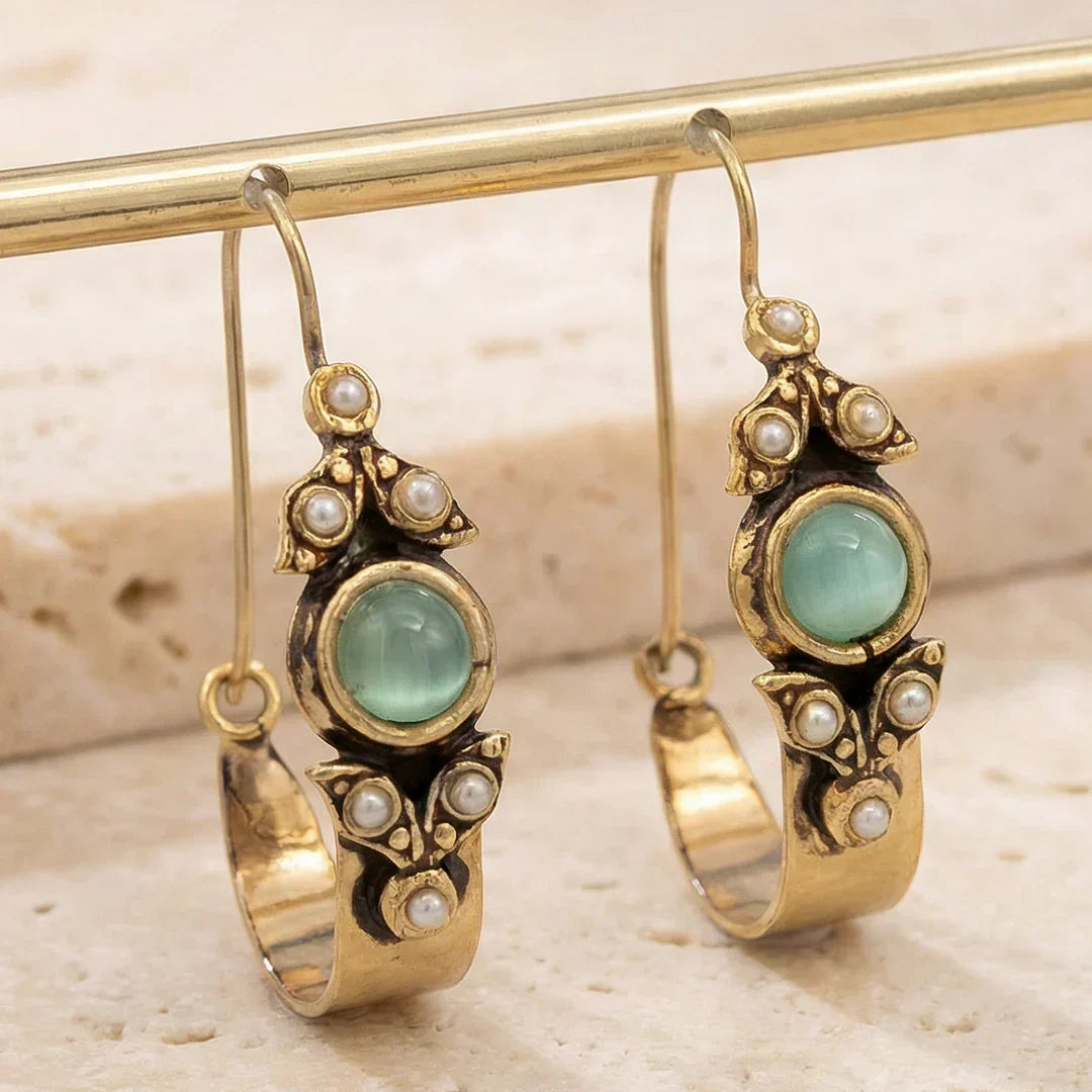 Retro pearl earrings with a green stone and a vintage design