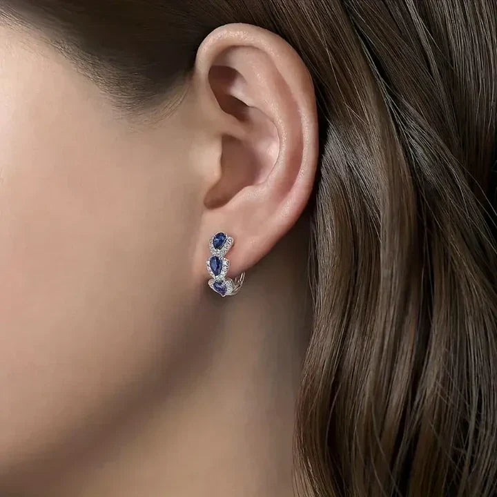 Elegant earrings featuring blue sapphire teardrops and sparkling cubic zirconia stones