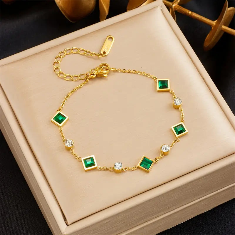 An elegant bracelet featuring square emerald stones and cubic zirconia