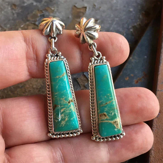 Vintage turquoise earrings with ornate silver-colored detailing