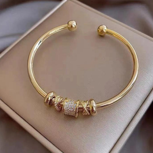 A sparkling bracelet featuring a cylinder set with cubic zirconia and elegant rings