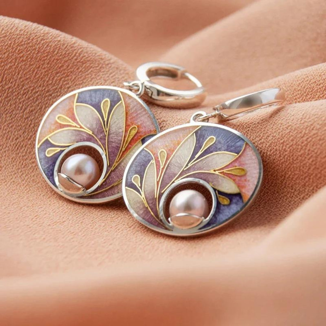 Elegant earrings featuring an enamelled leaf design and delicate pearls