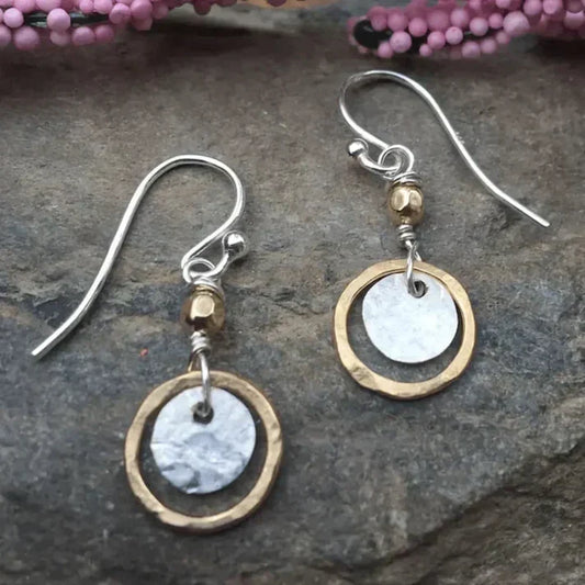 Handmade earrings featuring hammered brass rings and shiny discs