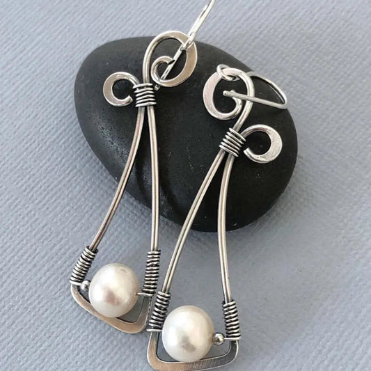 Vintage-style pearl earrings with a wrapped wire detail