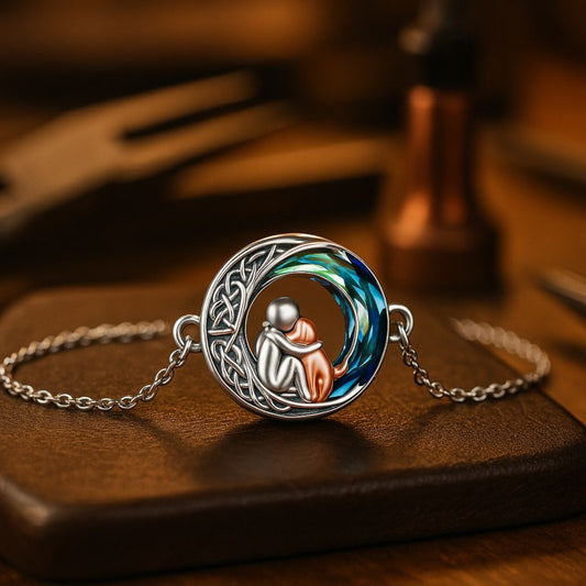 A bracelet featuring a human-dog figure with a sparkling moonstone and a naked Celtic figure