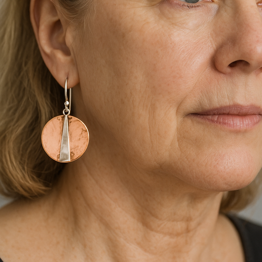 Hammered copper earrings with a narrow, modern brass strip