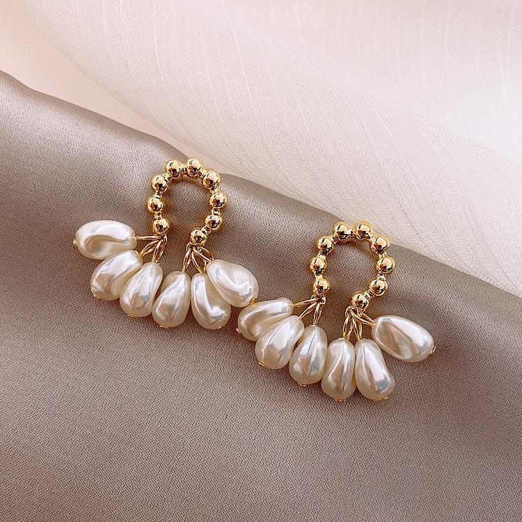 Elegant pearl earrings with delicate teardrop pendants for special occasions
