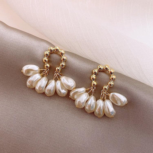 Elegant pearl earrings with delicate teardrop pendants for special occasions