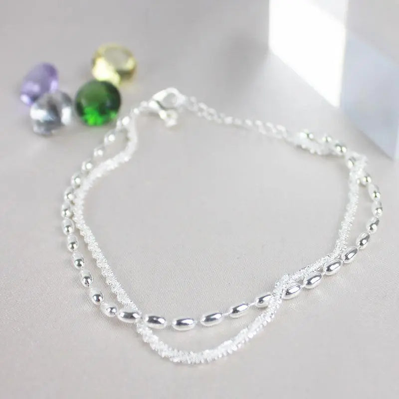 A glamorous cubic zirconia bracelet with an elegant pearl necklace