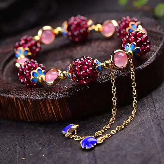 An exquisite garnet bracelet with rose quartz and blue enamel