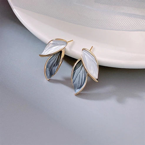 Elegant leaf-shaped earrings with a striking white-grey enamel finish