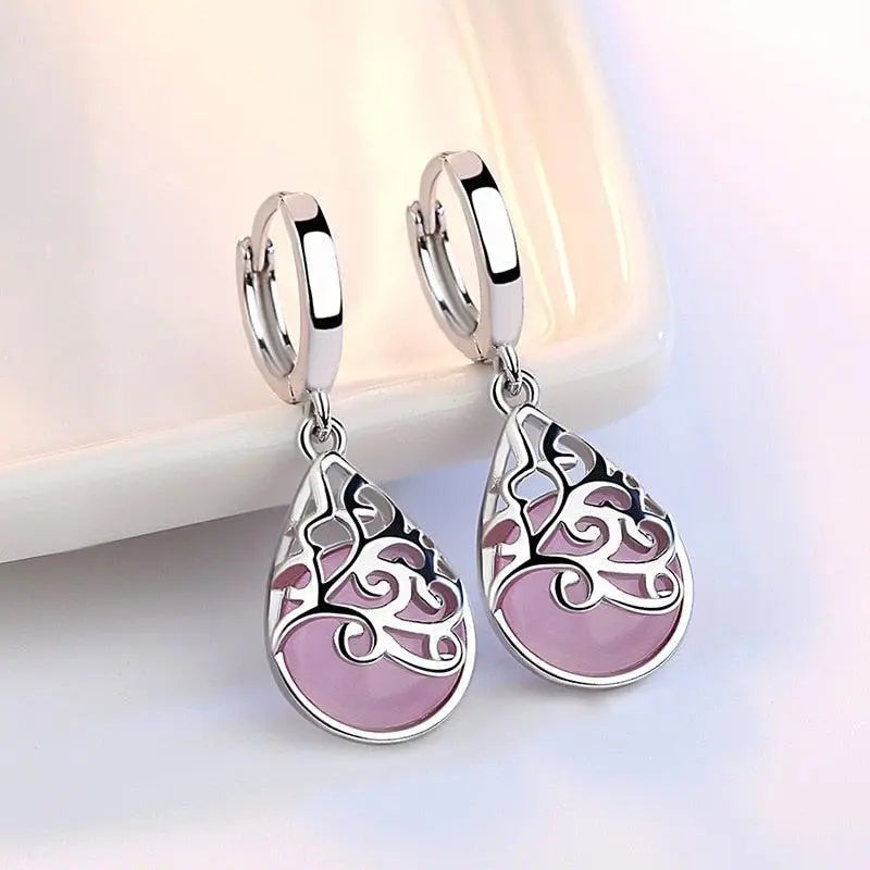 Elegant teardrop-shaped earrings with a pink stone and filigree design